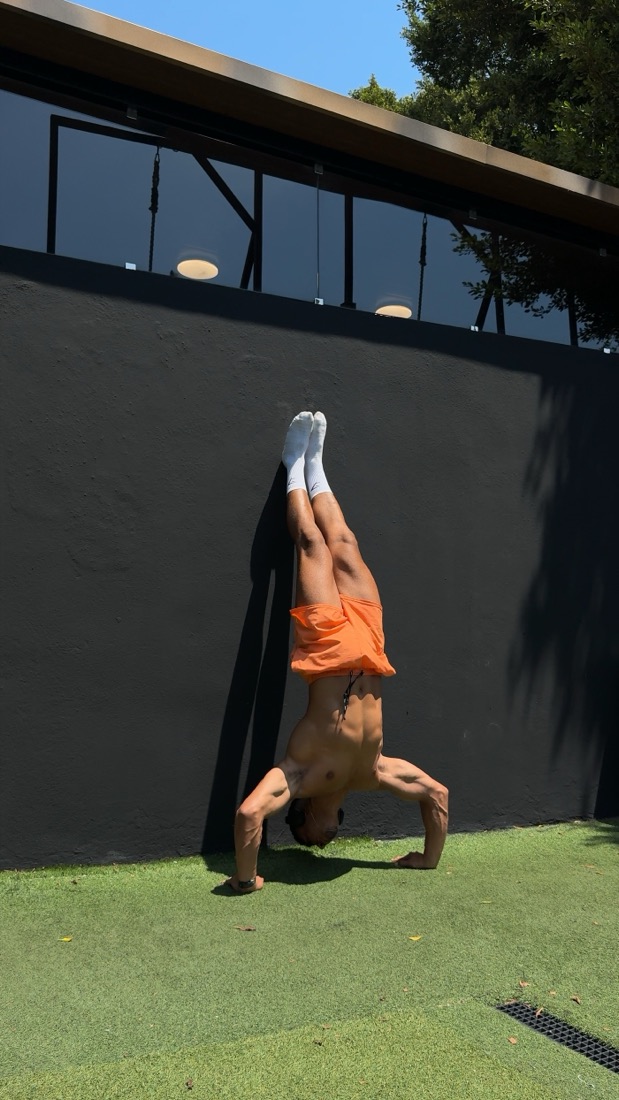 Frame from a technique video: wall handstand